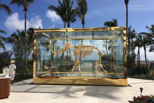 "Gilded woolly mammoth encased in glass vitrine"