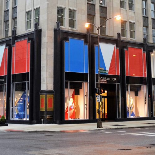Exterior view of the Palmolive Building, featuring Louis Vuitton's storefront. with Oversize low-iron laminates
