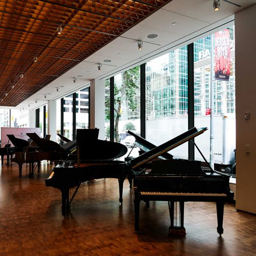 Inside Steinway & Sons looking at grand pianos and insulated glass units consisting of low-iron and low-e glass