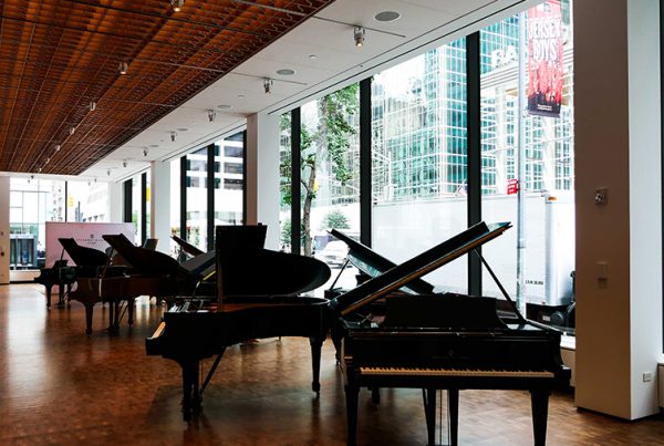 Inside Steinway & Sons looking at grand pianos and insulated glass units consisting of low-iron and low-e glass