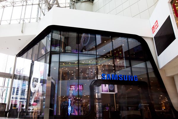 Interior mall view of all-glass façade for Samsung consists of oversized/jumbo, insulated, Low-E, glass units with complex, compound curves fabricated by AGNORA